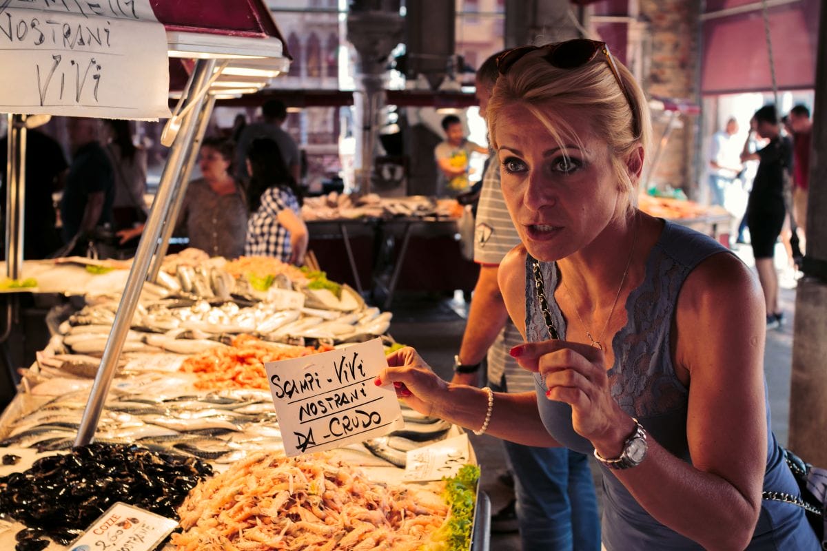 A woman at a fresh market in Venice. 