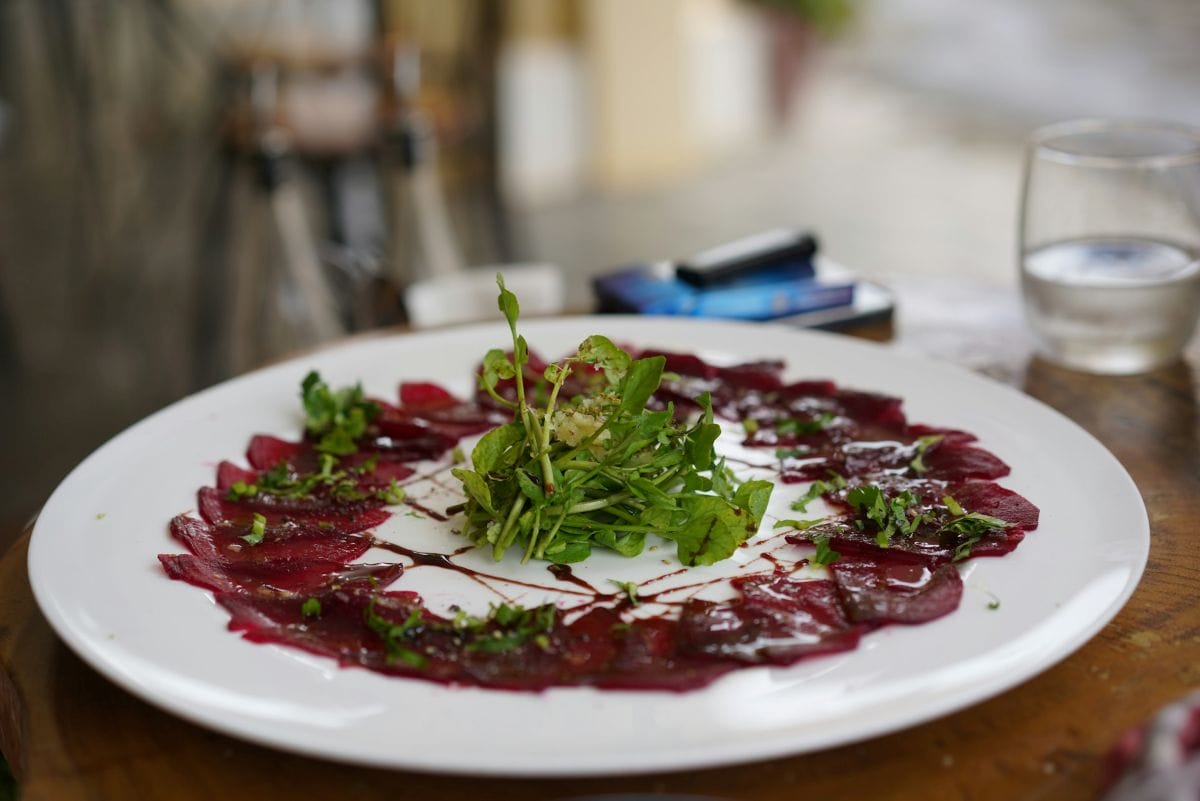 Carpaccio on a ceramic plate at a restaurant. 