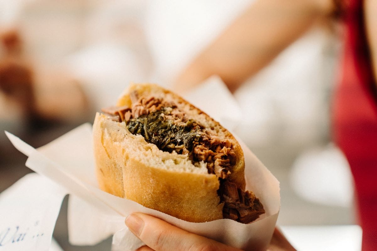 man holding panini sandwich