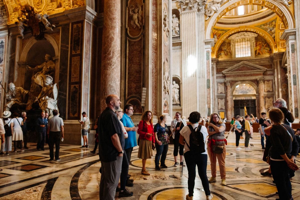 people standing in an ornate cathedral