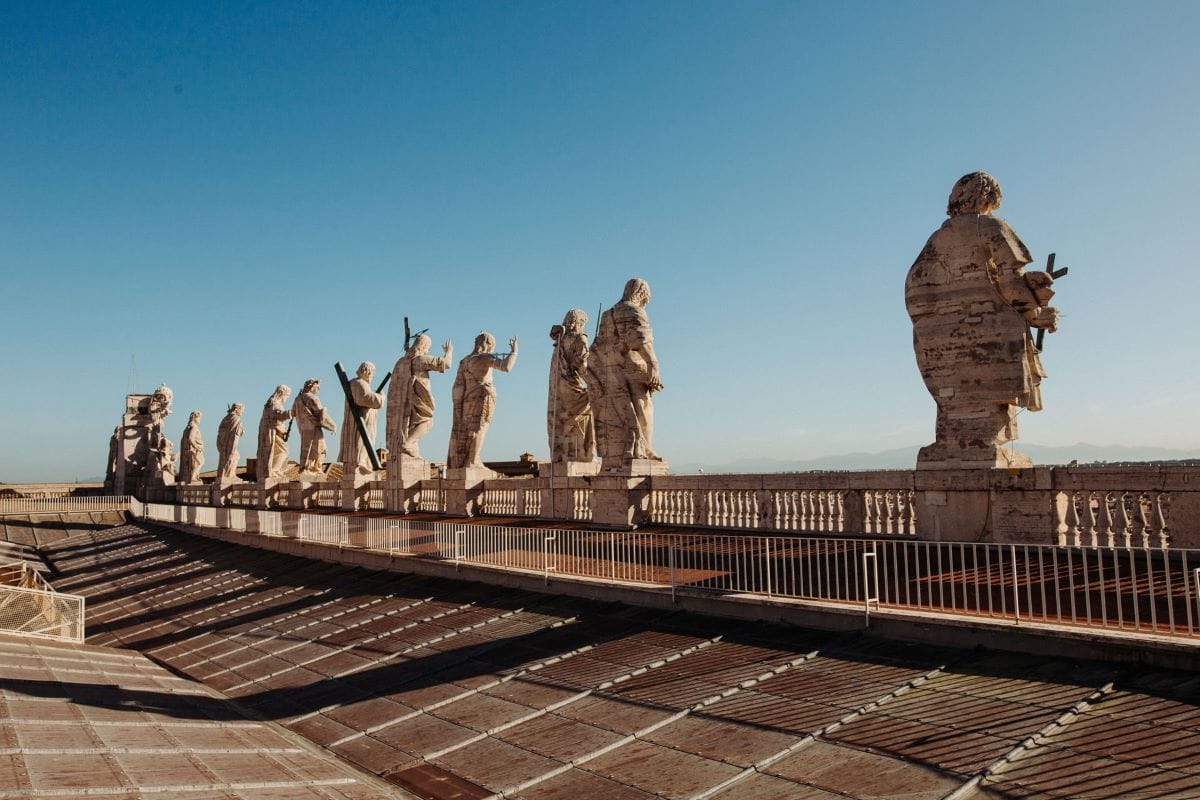 various statues lined up on rooftop