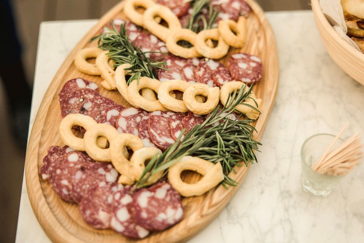 round wooden board with salami slices