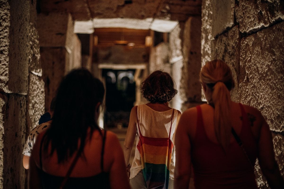 People walking through the halls of the Colosseum. 