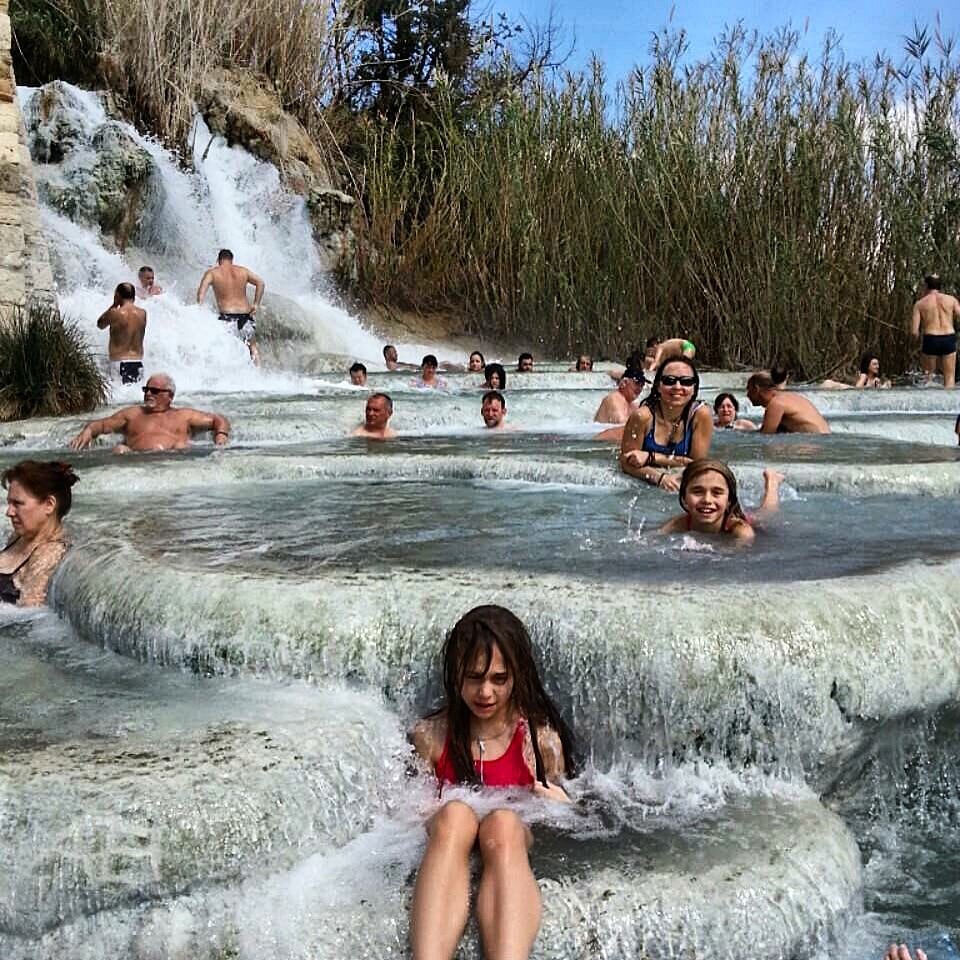 Bathers in the natural hot springs of Saturnia, one of the main attractions in the Tuscia region of Italy. 