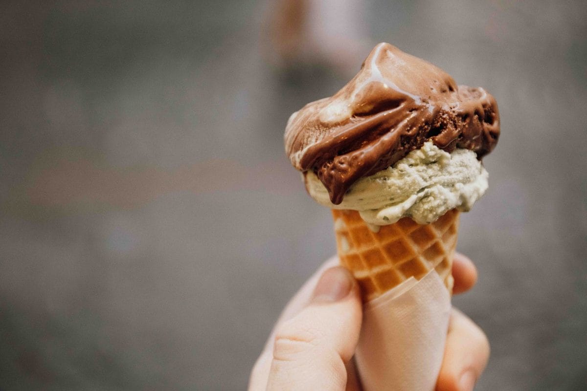 A person holding a gelato in a cone.