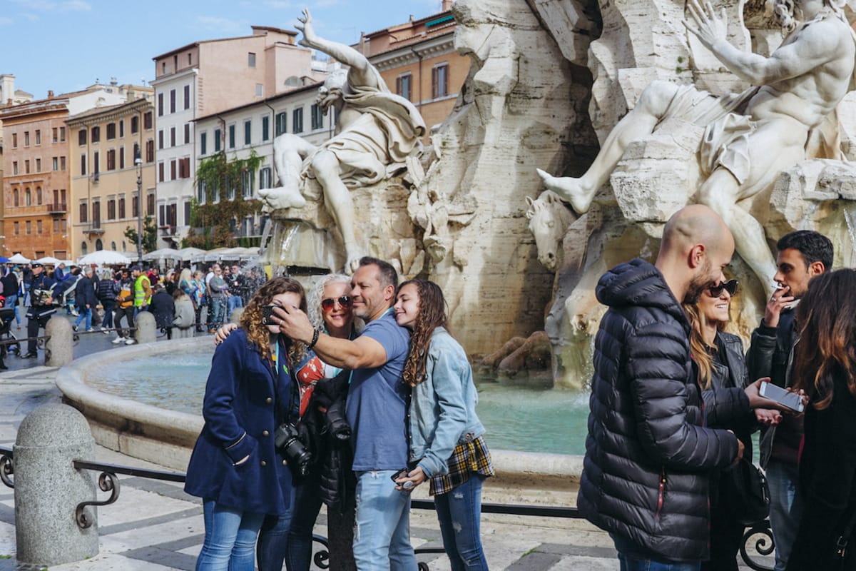 Tourists taking a picture at the Fountain of the Four Rivers