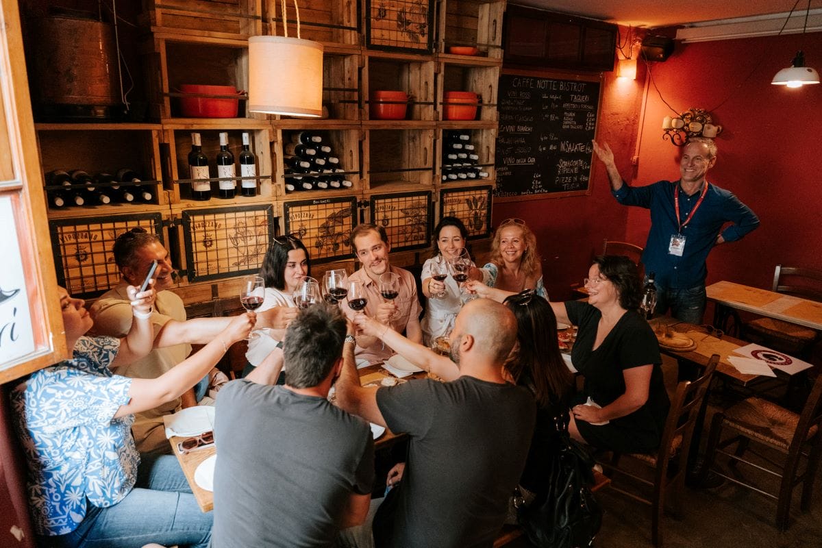 Group toasting to a meal in a Florentine restaurant