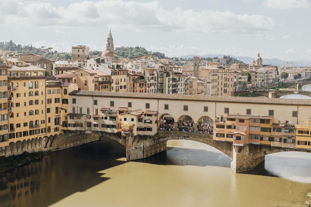 bridge spanning over river in italy