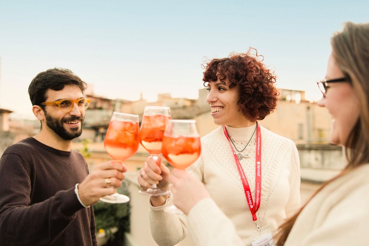 people on a rooftop toasting with glasses