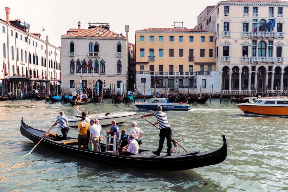 man steering a gondola through water