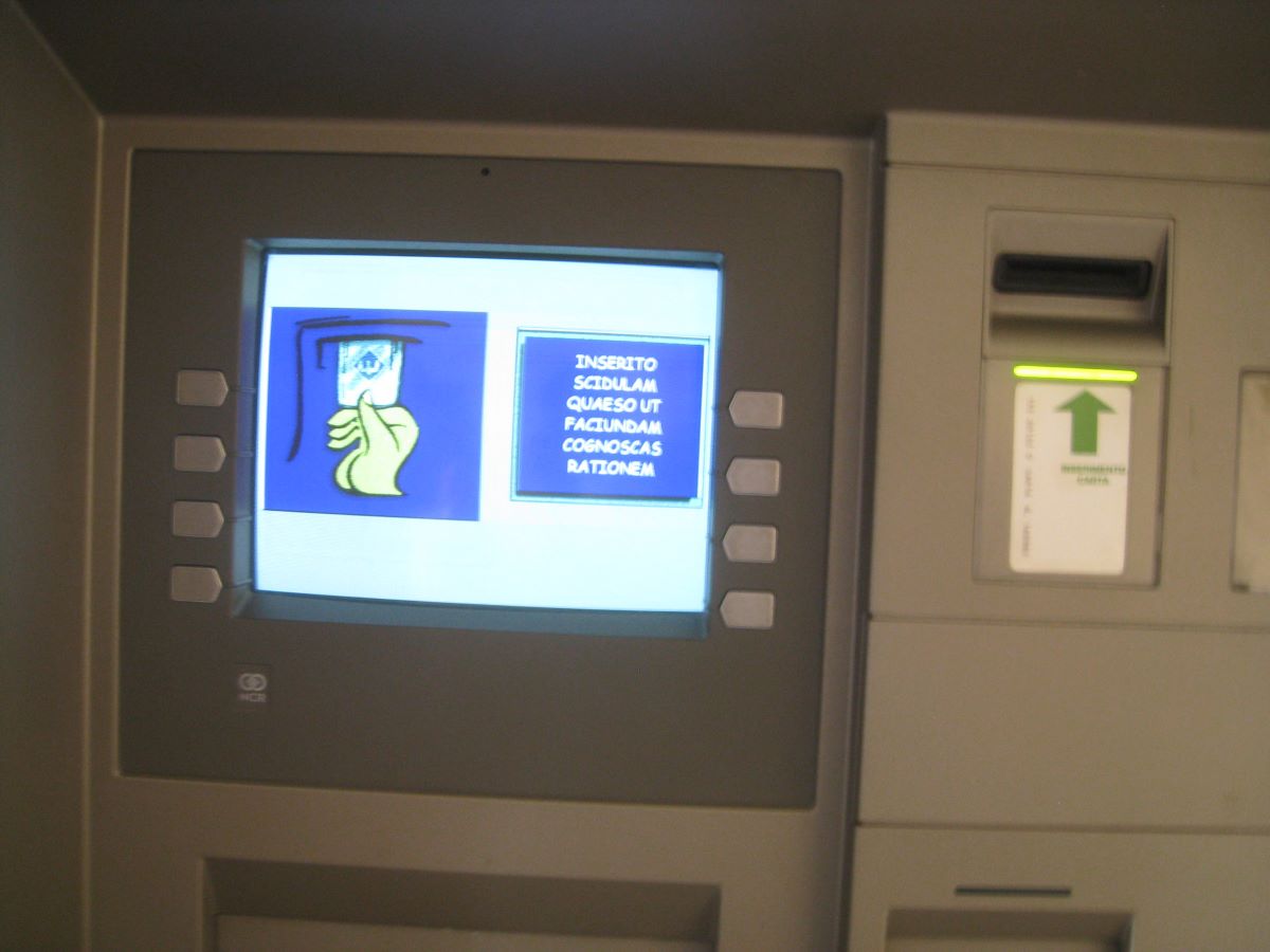 The front side of a atm machine with small screen and money slot