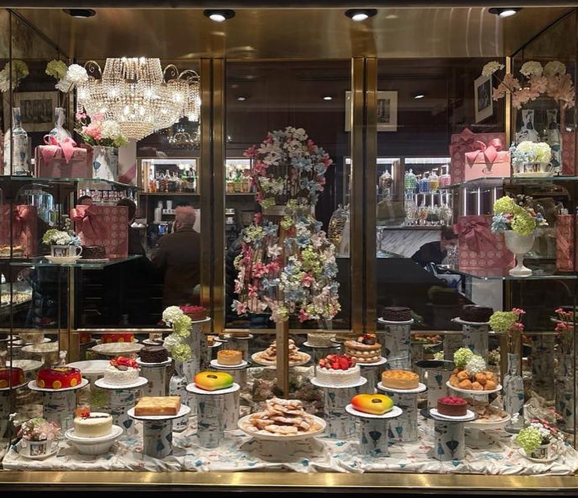 a bakery storefront with several sweet treats on display