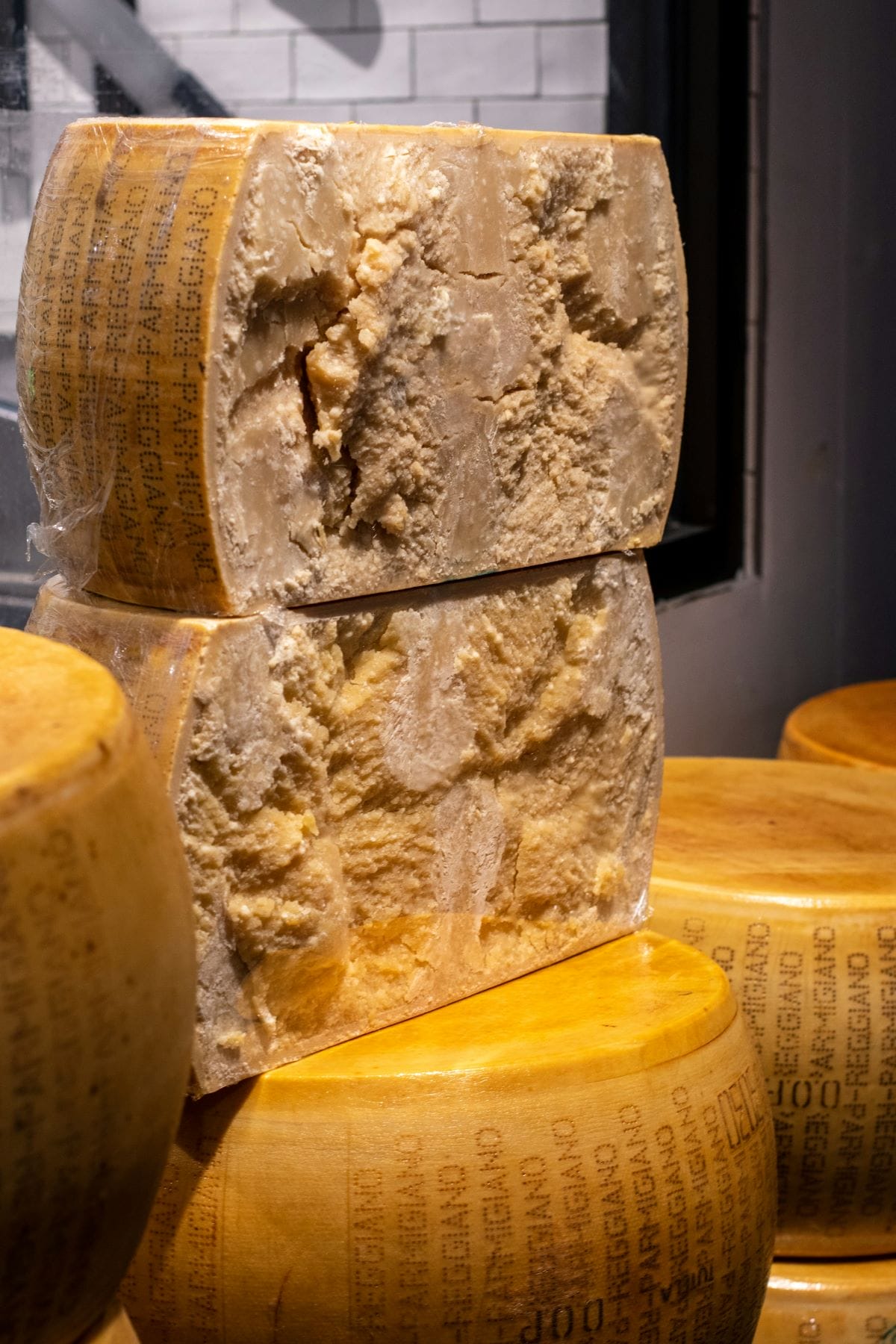 A wheel of parmigiano reggiano cheese cut in half.