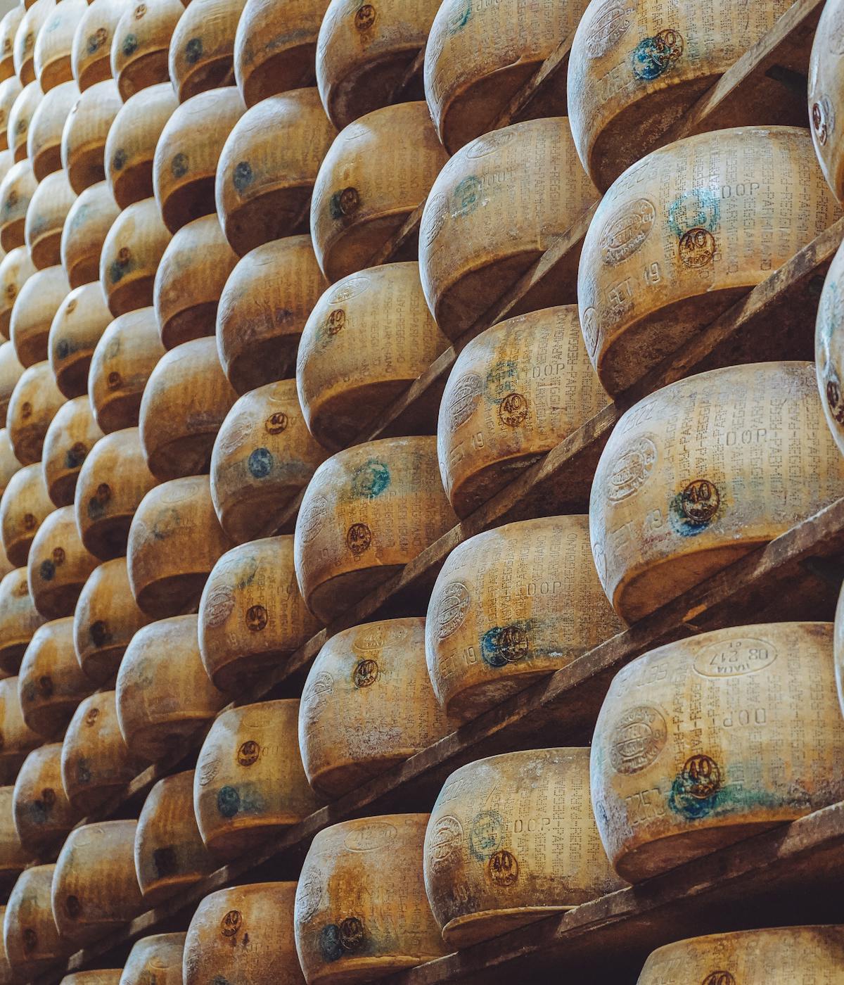 Rows of stacked DOP certified Parmigiano Reggiano cheese.