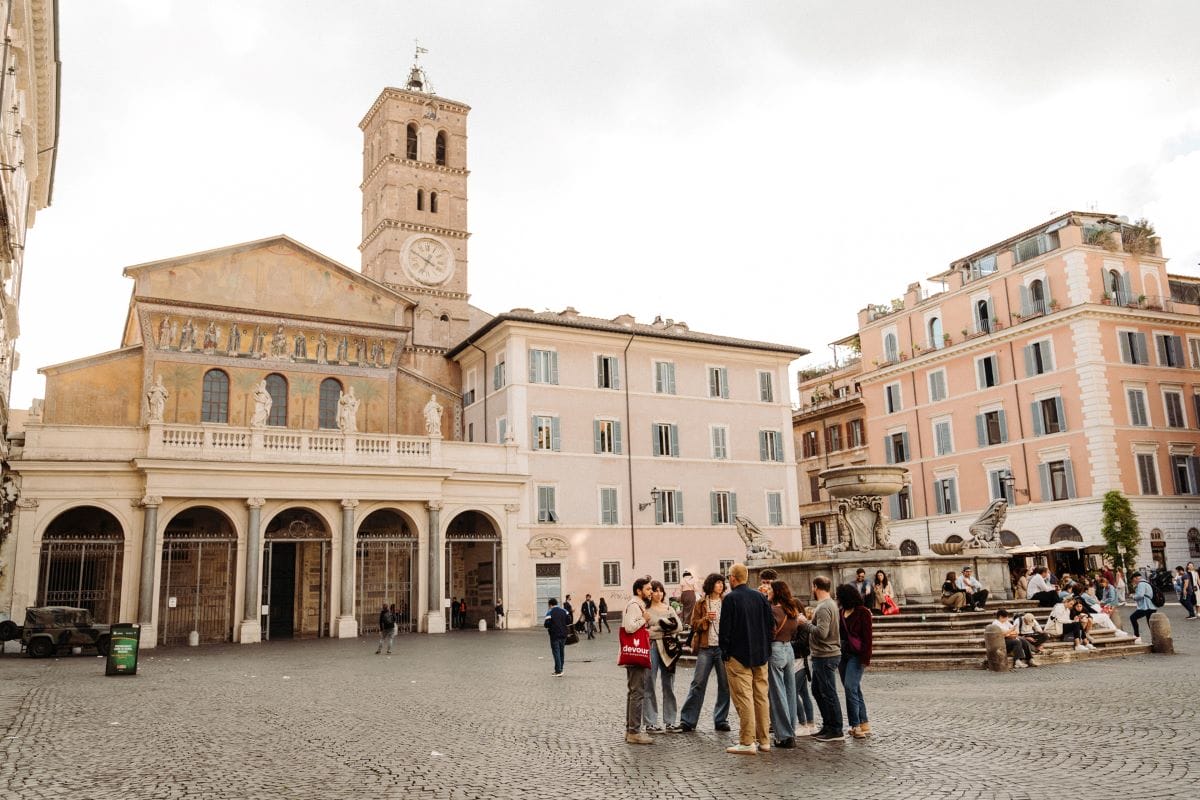 A group of people exploring Trastevere neighborhood.