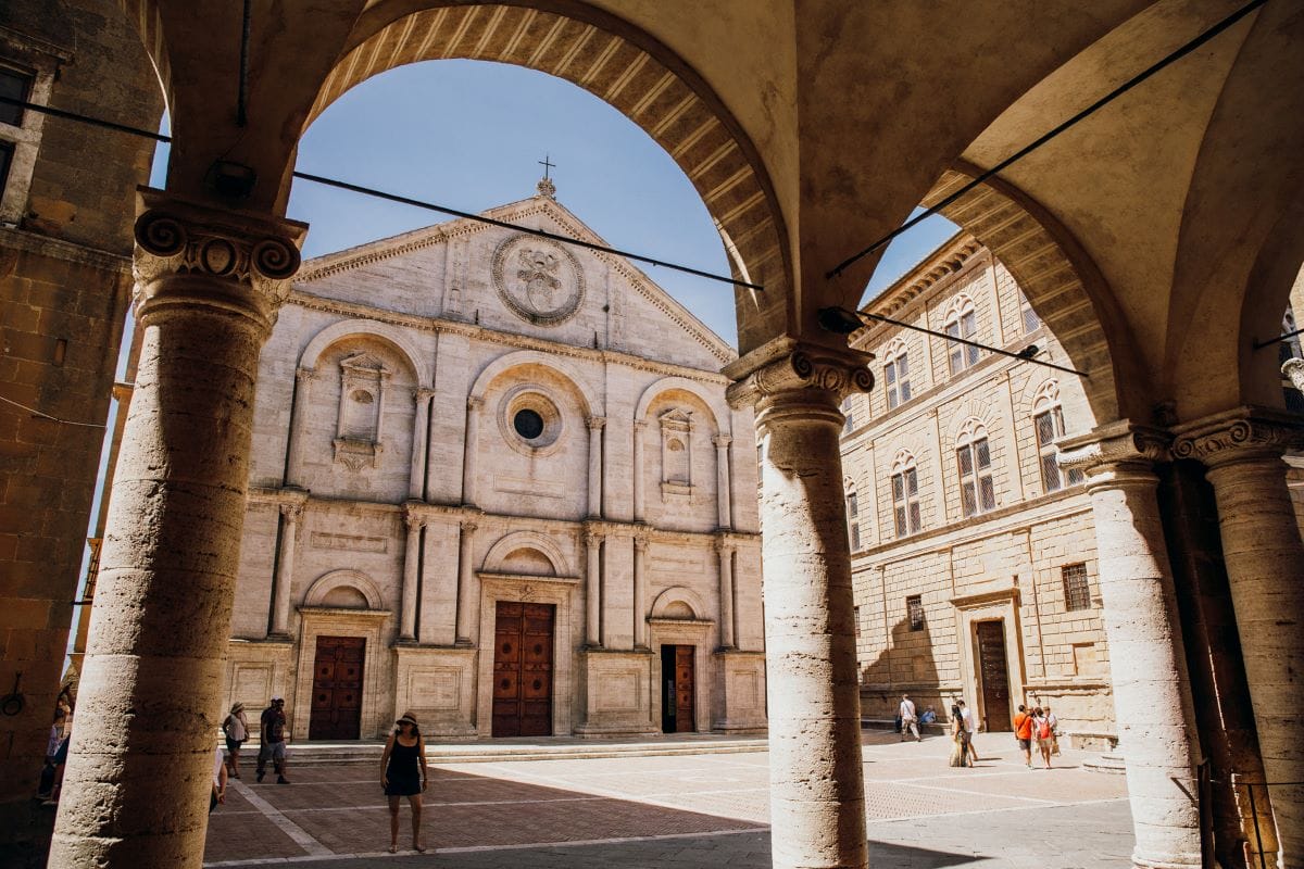 People walking a square in Pienza.