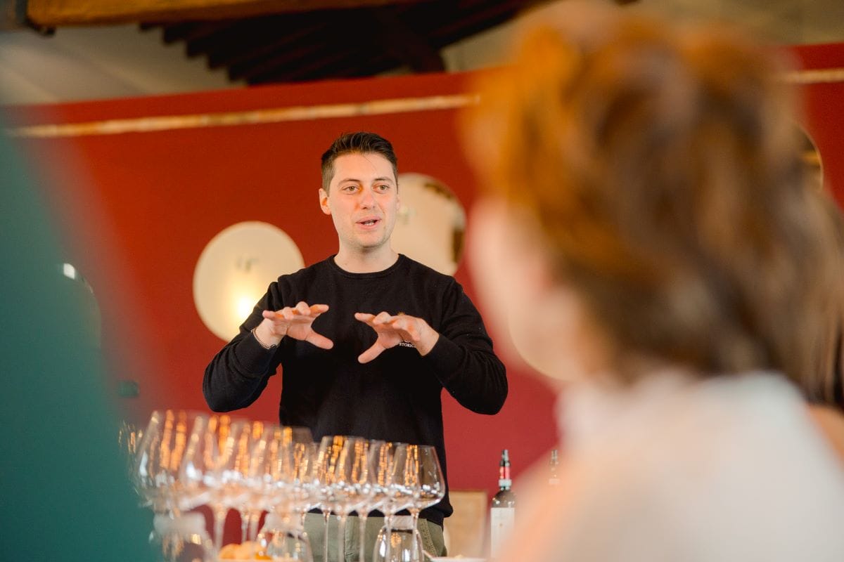 A sommelier explaining wine from Monticchiello, Italy.