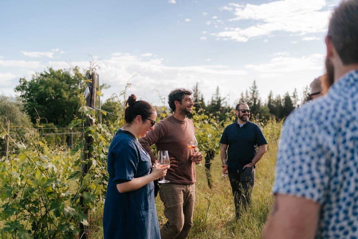 Tour guide with a glass of wine in the vineyard