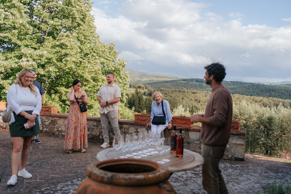 Group of people ready for a wine tasting in the countryside outdoors.