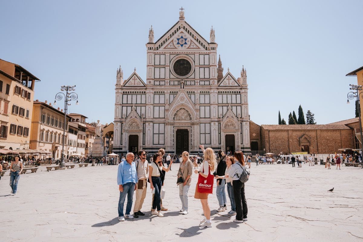 people standing on the street in front of an ornate cathedral