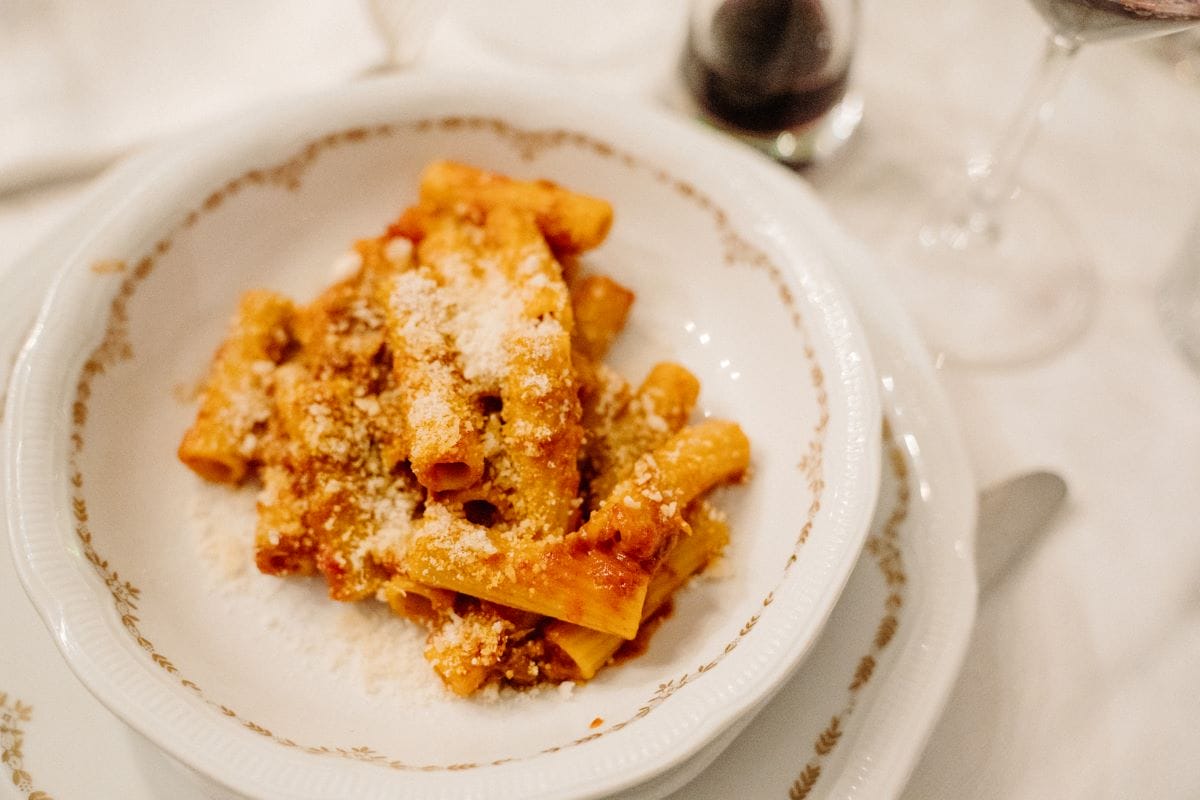 a plate of pasta with tomato sauce and cheese