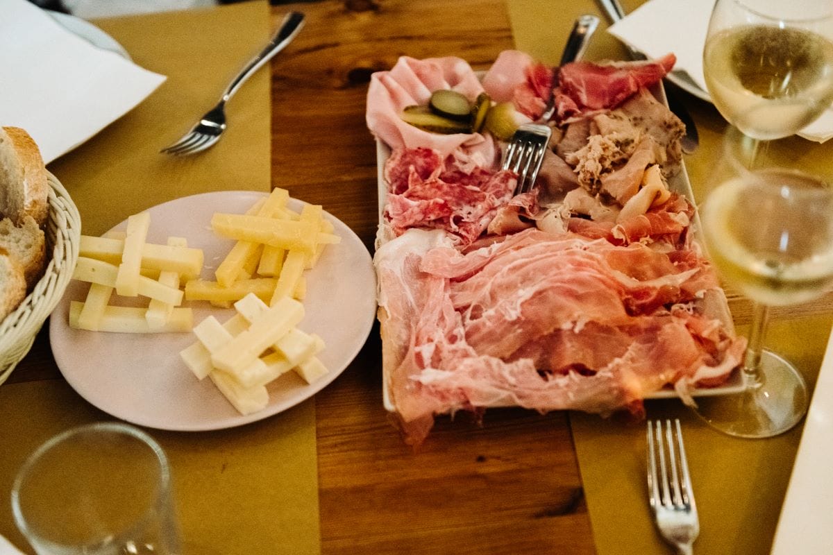 a table with plates of cheese and charcuterie