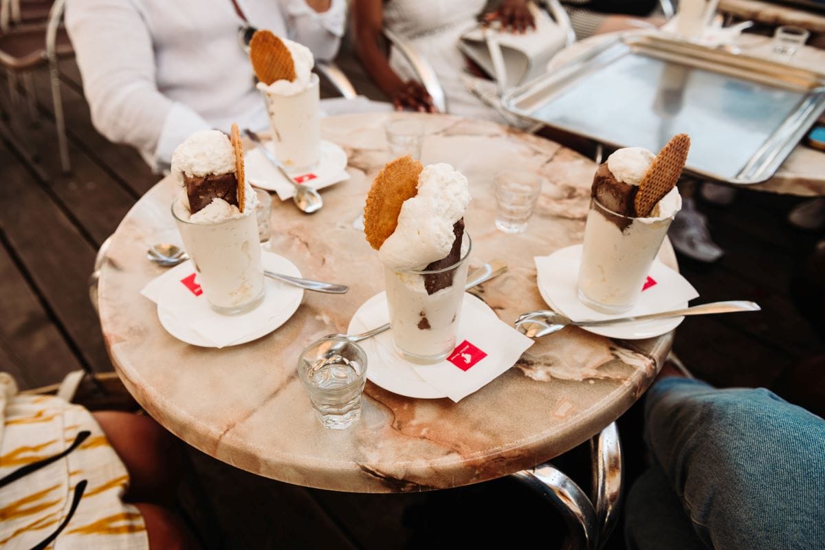 a round table with four glasses of ice cream