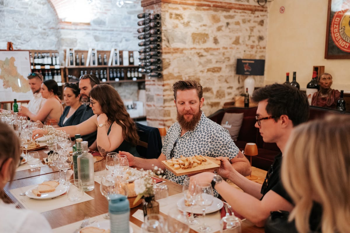 Person passing food in a table full of people