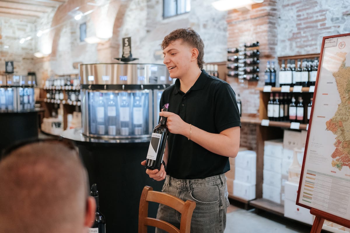 Person showing a bottle of Chianti red wine