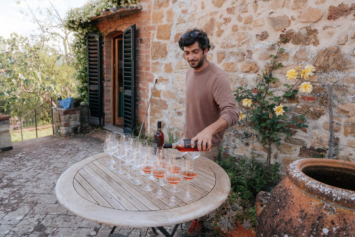 Person pouring glasses of wine