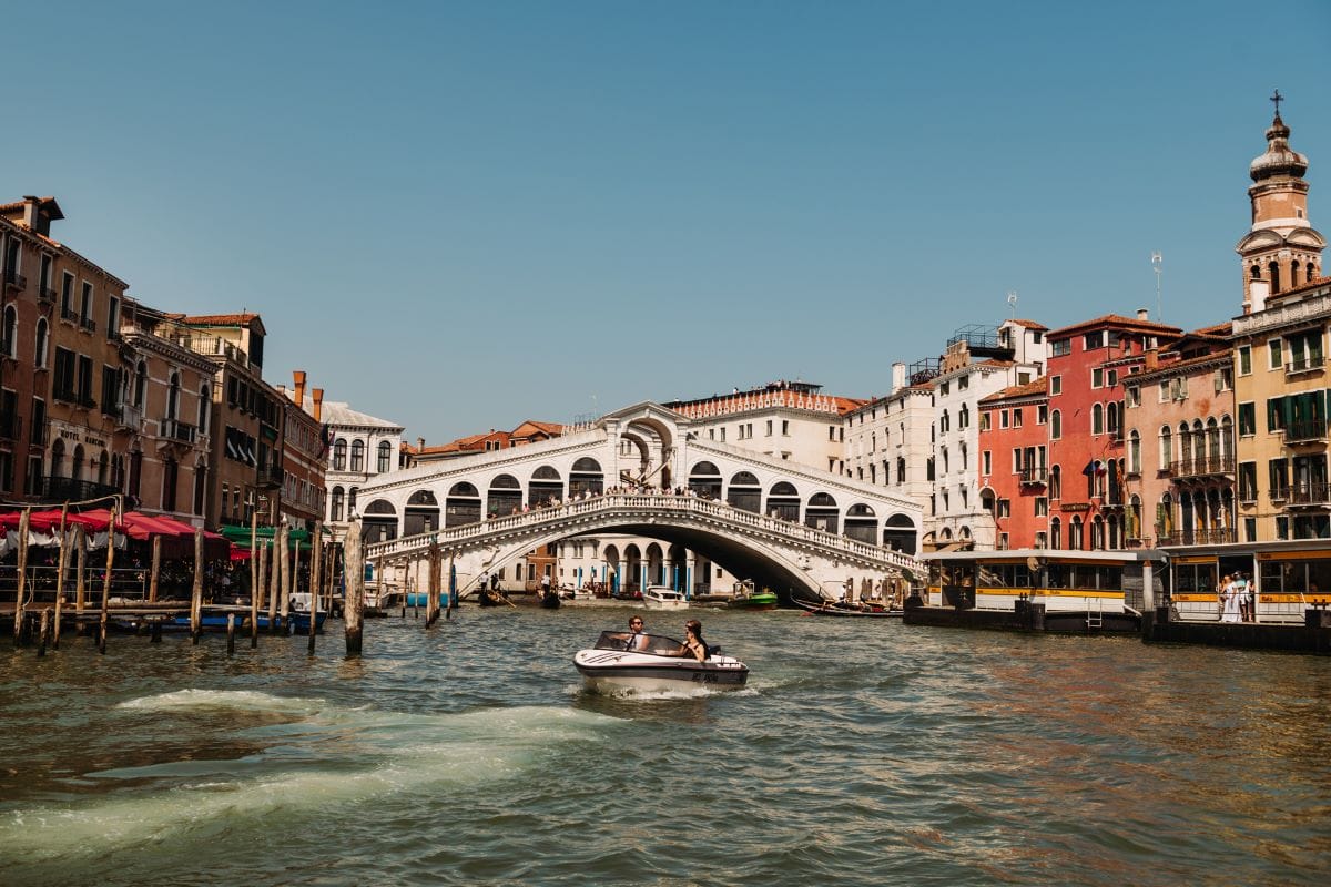 a walking bridge with various arches spanning over water