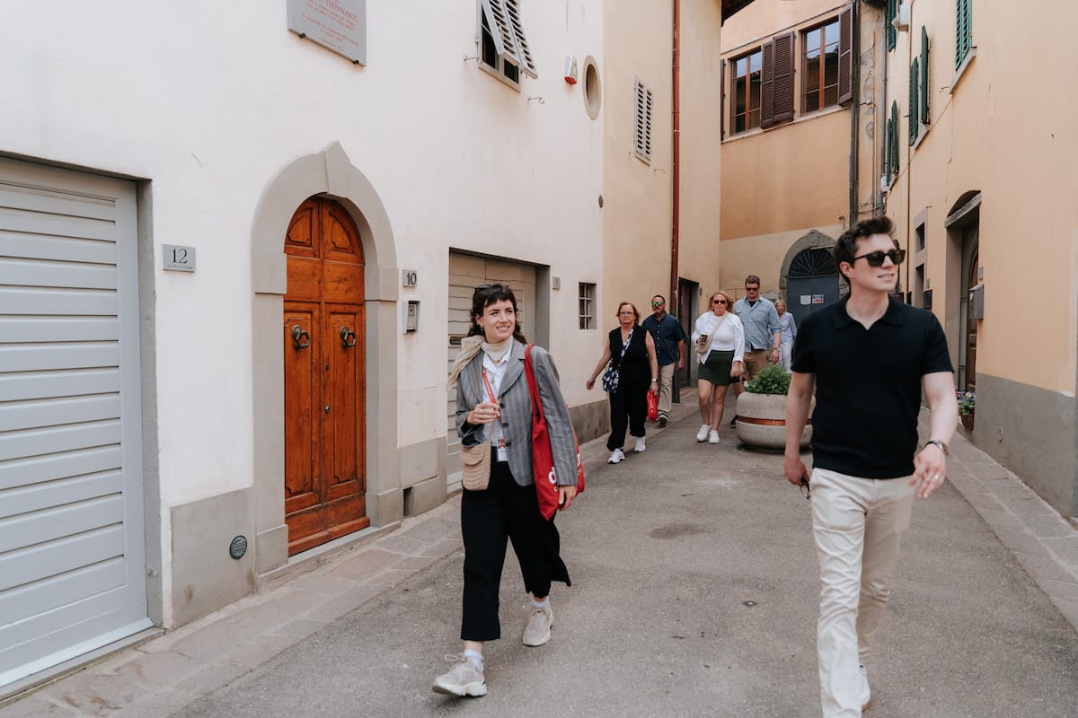 Group of people walking a Italian street, tour