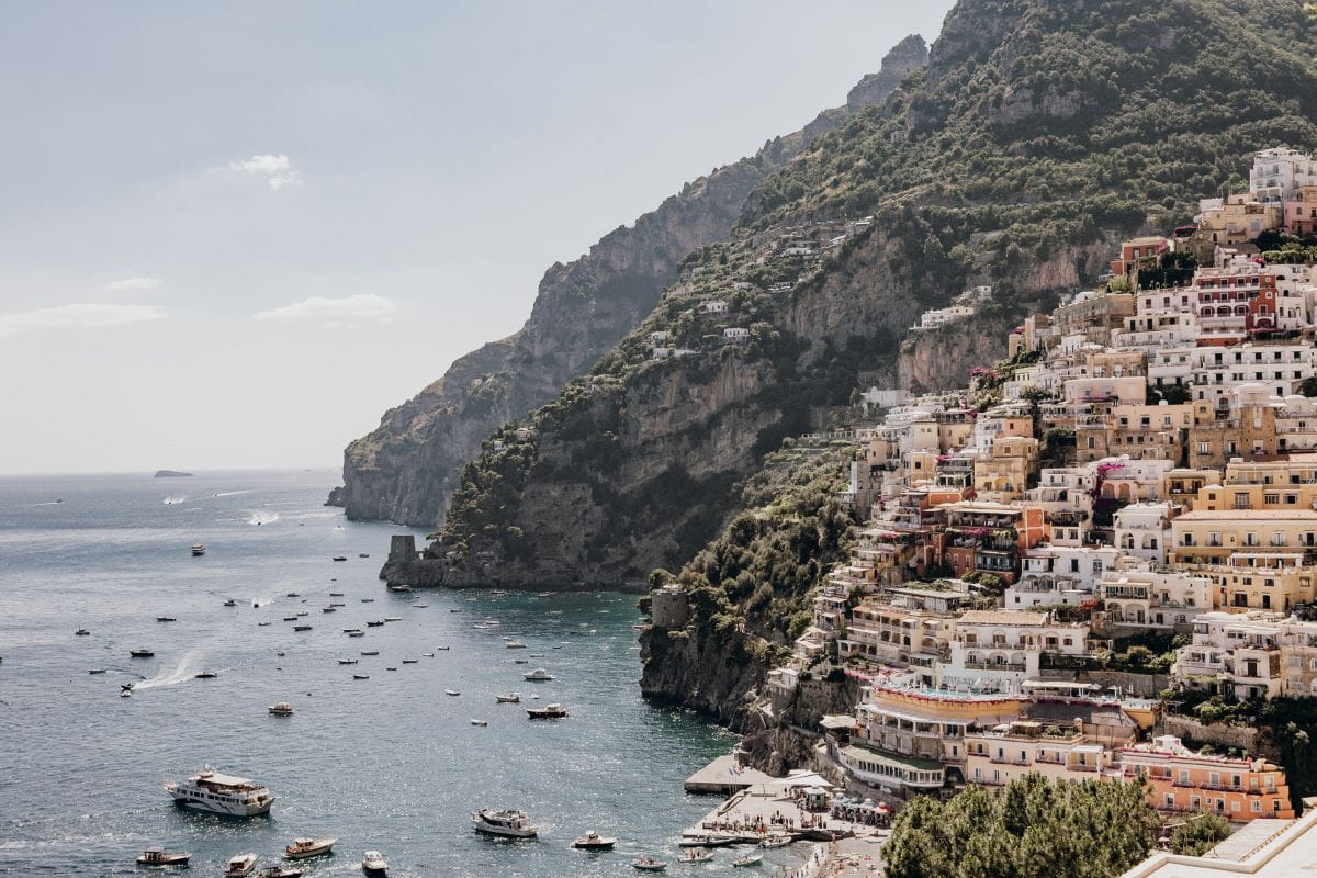 a beautiful view of colorful houses built on a cliffside overlooking the sea