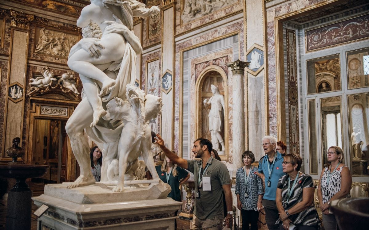 people looking at a large statue