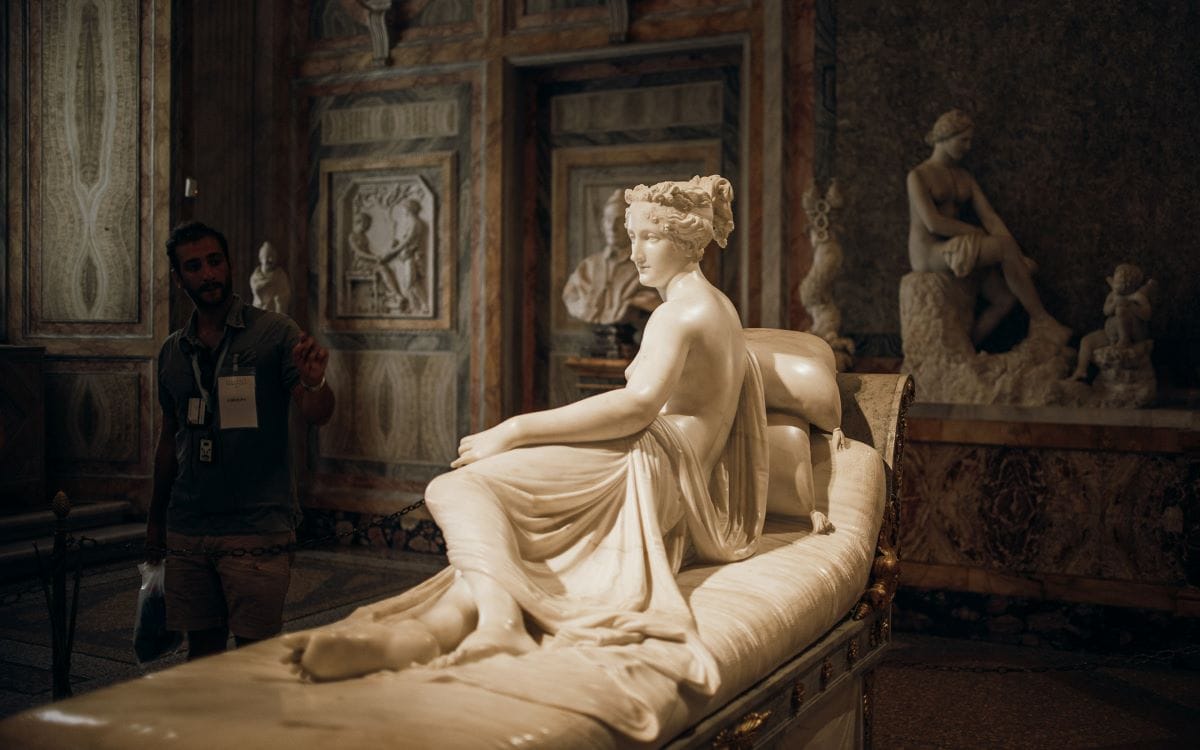 a statue of a woman laying on a bed