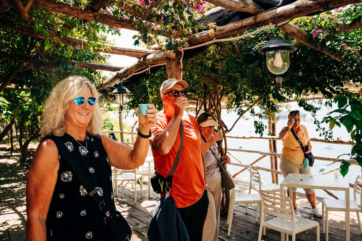 people enjoying a small beverage out of a small blue cup