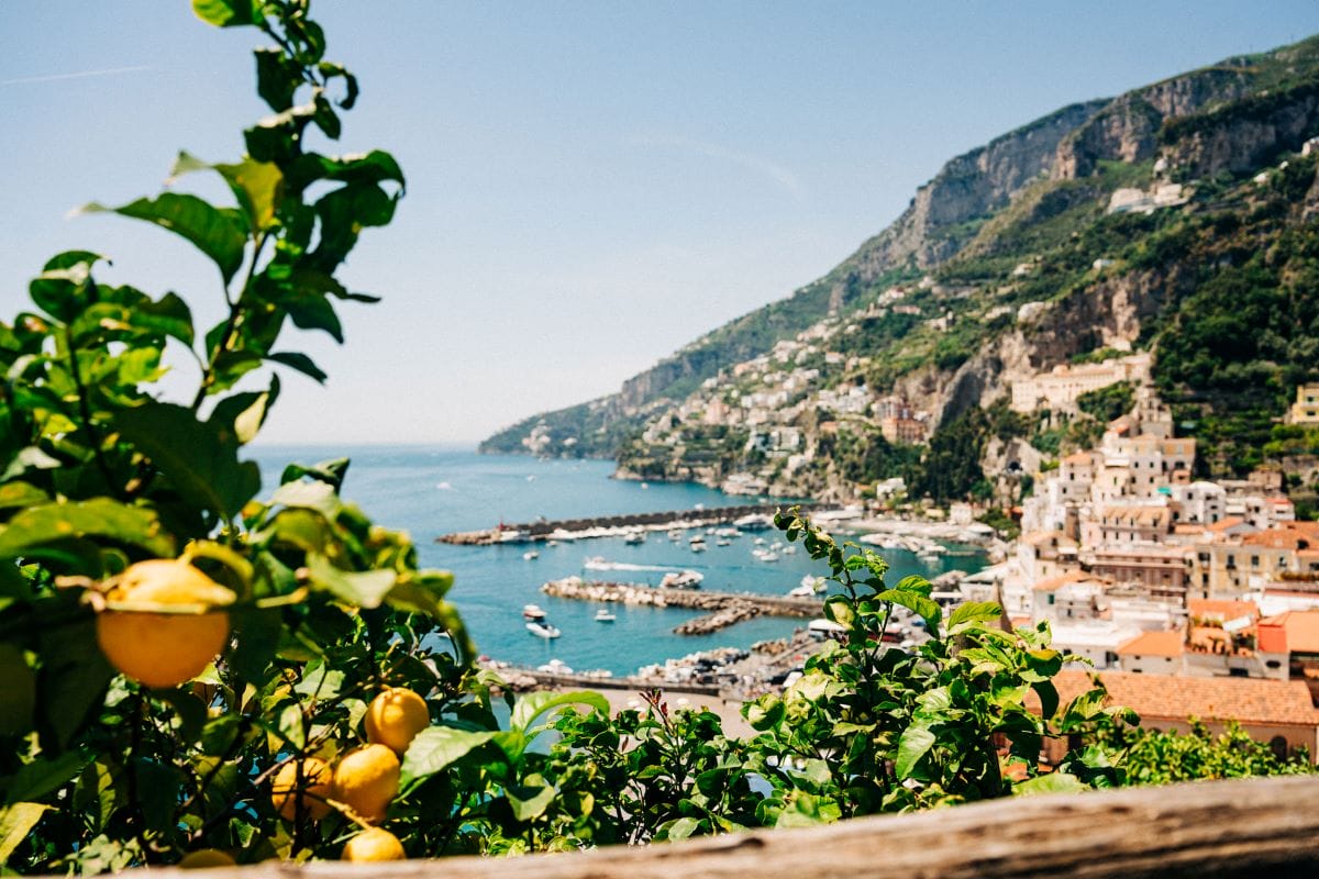 a beautiful view of colorful houses built on a cliffside overlooking the sea