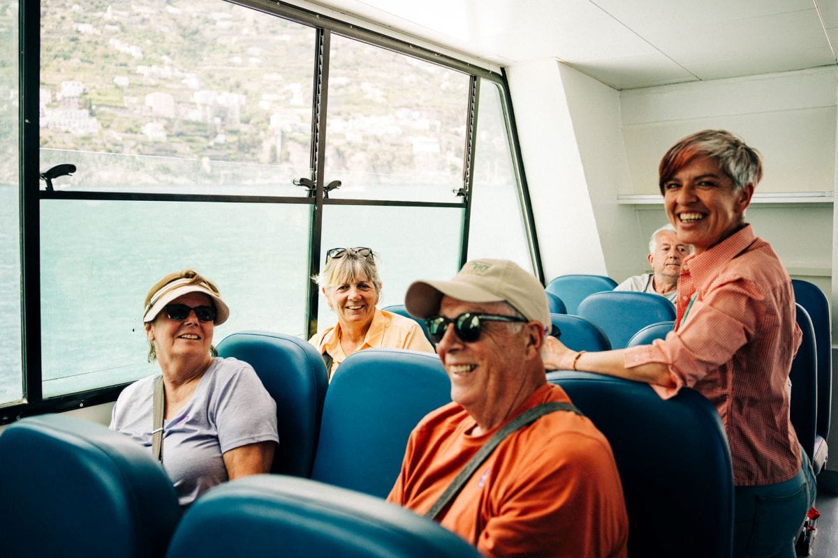 people smiling while on a boat ride